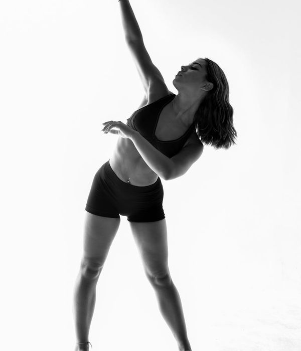 Woman performing a light cardio exercise in a bright studio.